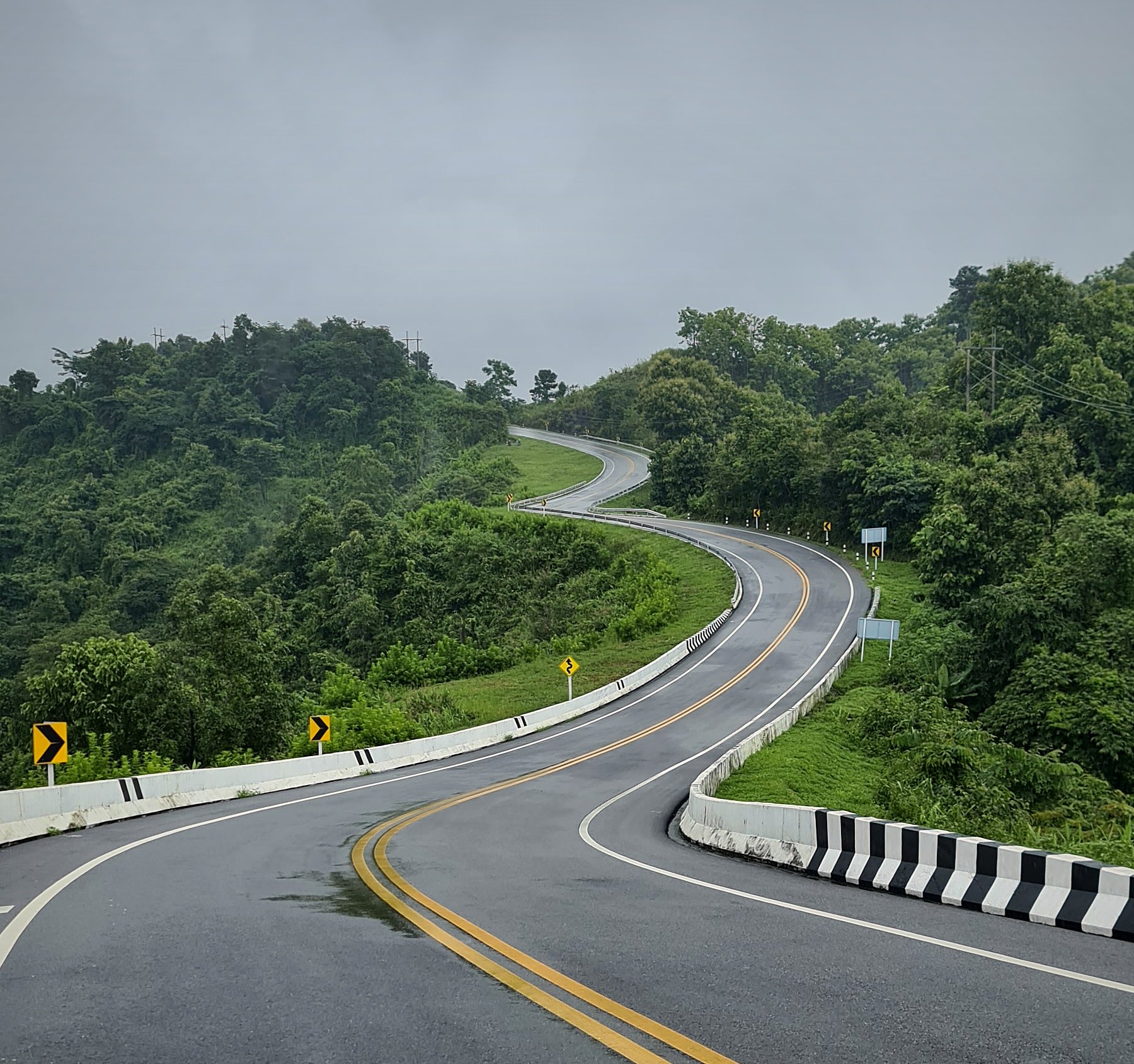 The 'number 3' road — Route 1081 near Santisuk, Nan — snaking along a forested ridge